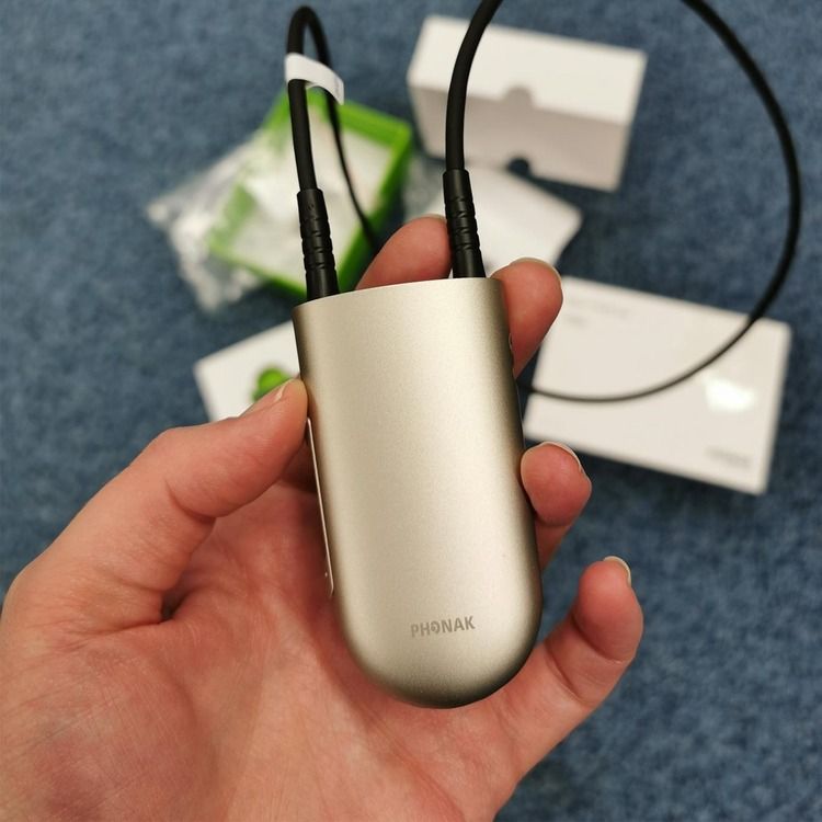 Hand holding a Phonak Roger neckloop
