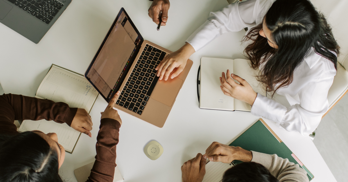 Corporate meeting at a table with laptop and phonak roger table mic 
